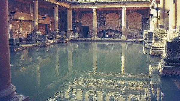 How can families save money on entry tickets to the Roman Baths in Bath?